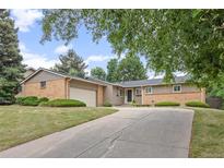 Charming single-Gathering home with brick and siding exterior, mature trees, and a large driveway at 888 E Davies Ave, Centennial, CO 80122