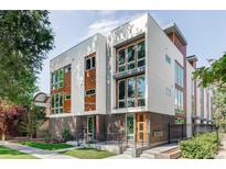 Modern townhome showcasing a contemporary facade with a brick base and an appealing mix of materials at 879 Delaware St, Denver, CO 80204