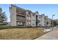 Charming condo complex featuring multi-level balconies, stone accents, and manicured landscaping at 12288 W Dorado Pl # 301, Littleton, CO 80127