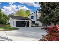 Beautifully designed home featuring a well-manicured lawn and an attached garage with a private driveway at 5516 S Havana Ct, Englewood, CO 80111