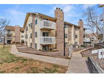 Condominium complex features brick accents and multiple stories with exterior balconies and mature trees at 12502 E Cornell Ave # 304, Aurora, CO 80014
