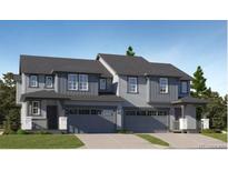 Charming two-story home featuring a modern design, complemented by a two-car garage and inviting entryway at 557 Nightsky St, Erie, CO 80516
