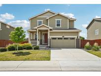 Charming two-story home with a well-manicured lawn, attached garage, and inviting curb appeal at 2682 E 161St Pl, Thornton, CO 80602