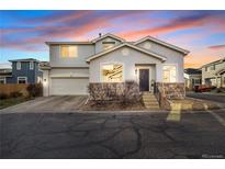 Two-story house with gray siding, stone accents, and a two-car garage at 10147 Wyandott N Cir, Thornton, CO 80260