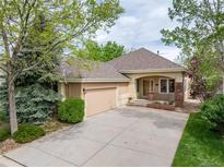 Charming single-story home with a well-manicured lawn, inviting curb appeal, and an attached two-car garage at 15851 Deer Ridge Dr, Morrison, CO 80465