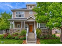Charming two-story home with a welcoming front porch, stone accents, and lush landscaping at 4921 Fountain St, Boulder, CO 80304
