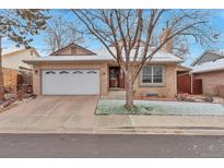 Charming single-story brick home featuring a two-car garage and manicured front yard at 710 Kittredge St, Aurora, CO 80011