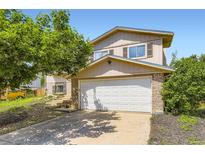 Charming two-story home with a two-car garage and mature landscaping at 3235 S Newland St, Denver, CO 80227