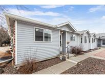 Charming home with tidy landscaping, a welcoming entrance, and neutral toned siding at 2027 Terry St # 1, Longmont, CO 80501