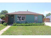 Charming single-story home features a well-maintained lawn and beautiful flower beds along the front of the house at 1730 W 51St Ave, Denver, CO 80221