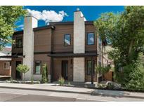 Beautiful home featuring a wood facade, stone accents, front porch, and manicured landscaping at 21 Washington Ave, Golden, CO 80403
