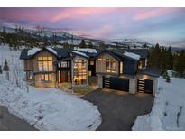 Stunning exterior view of mountain home with snow-covered landscape and attached garage at 444 Glen Eagle Loop, Breckenridge, CO 80424