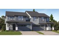 Charming townhome with a two-car garage, covered porch and a professionally landscaped front yard at 587 Nightsky St, Erie, CO 80516