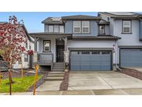 Charming two-story townhome with a two-car garage and welcoming front porch at 587 Nightsky St, Erie, CO 80516