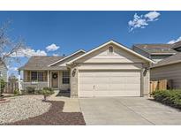 Charming single-story home with a two-car garage, inviting front porch, and easy-to-maintain landscaping at 5400 S Quail Way, Littleton, CO 80127