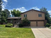 Charming two-story home featuring a well-maintained lawn and a convenient two-car garage at 8893 W Harvard Dr, Lakewood, CO 80227