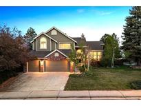 Charming two-story home with a three-car garage and beautifully landscaped front yard at 2317 Wynterbrook Dr, Highlands Ranch, CO 80126