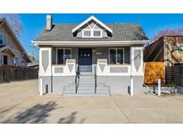 Charming home with a symmetrical facade, prominent front steps, and gray color scheme at 3929 Federal Blvd, Denver, CO 80211