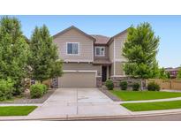 Two-story home with a two-car garage, stone accents, and manicured landscaping at 286 Western Sky Cir, Longmont, CO 80501