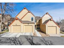 Charming townhome featuring attached garages and well-maintained landscaping under a sunny sky at 10349 W Fair Ave # B, Littleton, CO 80127