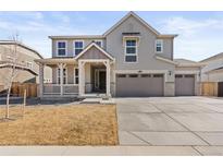 Charming two-story home featuring a welcoming front porch and a three-car garage at 14842 Fairfax St, Thornton, CO 80602