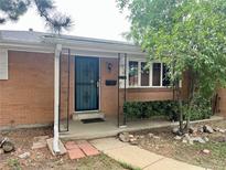 Charming brick home featuring a landscaped front yard and welcoming entrance at 1088 Douglas Dr, Denver, CO 80221