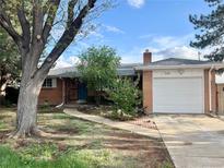 Charming single-story home with brick exterior, manicured lawn, and attached garage in a residential neighborhood at 1088 Douglas Dr, Denver, CO 80221