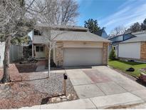 Charming two-story home with a brick and siding facade, two-car garage, and well-kept front yard at 3968 S Atchison Way, Aurora, CO 80014
