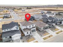 Aerial view of home in a neighborhood with well-maintained lawns, mature trees, and convenient access to local amenities at 1408 Brookfield Pl, Lafayette, CO 80026