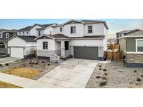 Charming two-story home featuring a two-car garage and well-maintained front yard at 1408 Brookfield Pl, Lafayette, CO 80026