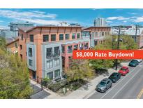 Modern townhouse boasts a rate buydown, balconies, and a gated front yard with mature trees at 3295 Blake St # 301, Denver, CO 80205