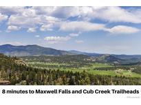 Breathtaking mountain and valley views with lush forests and expansive blue skies, an ideal setting for nature lovers at 6882 Snowshoe Trl, Evergreen, CO 80439