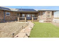 Charming brick home featuring a welcoming porch and a stone pathway leading to the front door at 44000 E 88Th Ave, Bennett, CO 80102