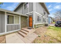 Charming exterior showcasing the front door, brick accents, and well-maintained landscaping at 1212 S Uvalda St, Aurora, CO 80012