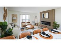 Bright living room featuring modern decor, wood slat accent wall and fireplace at 3450 S Poplar St # 307, Denver, CO 80224