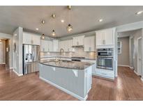 Modern kitchen featuring granite countertops, stainless steel appliances, and stylish pendant lighting at 23957 E Rocky Top Ave, Aurora, CO 80016