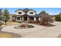 Charming home featuring stone accents, a circular driveway, and beautiful landscaping at 5375 Twilight Way, Parker, CO 80134