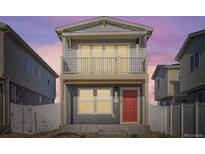 Charming two-story home with a balcony and a red front door under a beautiful sky at 5035 N Walden Way, Denver, CO 80249