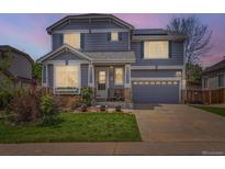 Charming two-story home with a well-manicured lawn, inviting entrance, and an attached two-car garage at 11569 Grape St, Thornton, CO 80233