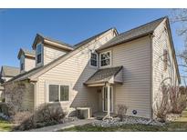 Beige townhouse exterior with covered front entrance and well-kept landscaping features at 2122 S Victor St # F, Aurora, CO 80014