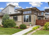 Modern home featuring a well-manicured lawn and a unique architectural design with ample natural light at 1340 W 68Th Ave, Denver, CO 80221