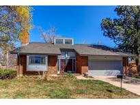 Charming red brick single-Gathering home with a two-car garage and manicured front lawn at 11651 E Yale Way, Aurora, CO 80014