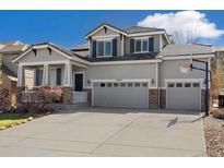 Charming two-story home features a three-car garage, solar panels, and beautiful stone accents at 2208 Bellavista St, Castle Rock, CO 80109