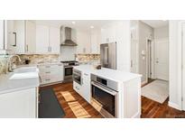 Well-equipped kitchen with white cabinets, stainless steel appliances, and quartz countertops at 2208 Bellavista St, Castle Rock, CO 80109