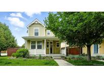 Charming two-story home with landscaped front yard, inviting porch, and appealing curb appeal at 2648 Florence St, Denver, CO 80238