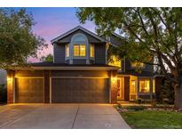 Charming two-story home with a three car garage, well-manicured lawn, and classic architectural details at 9912 Silver Maple Rd, Highlands Ranch, CO 80129