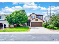 Inviting two-story home with a cozy front porch and a well-manicured lawn at 22160 Wintergreen Way, Parker, CO 80138