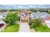 Charming two-story home with a well-maintained lawn and a two-car garage at 22160 Wintergreen Way, Parker, CO 80138