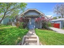 Charming home with a well-manicured lawn and inviting front porch at 833 Osceola St, Denver, CO 80204