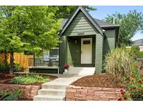 Charming home with an inviting front porch, beautiful landscaping, and a well-maintained exterior at 1331 Osceola St, Denver, CO 80204